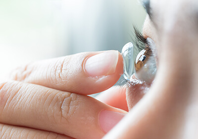 Closeup of a Woman Putting Contact Lenses In