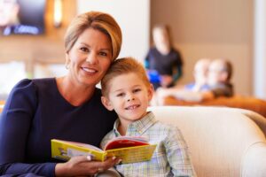 Mother and son at VisionPoint Eye Center in the waiting room reading a book