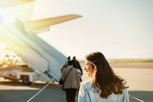 Woman stepping onto plane